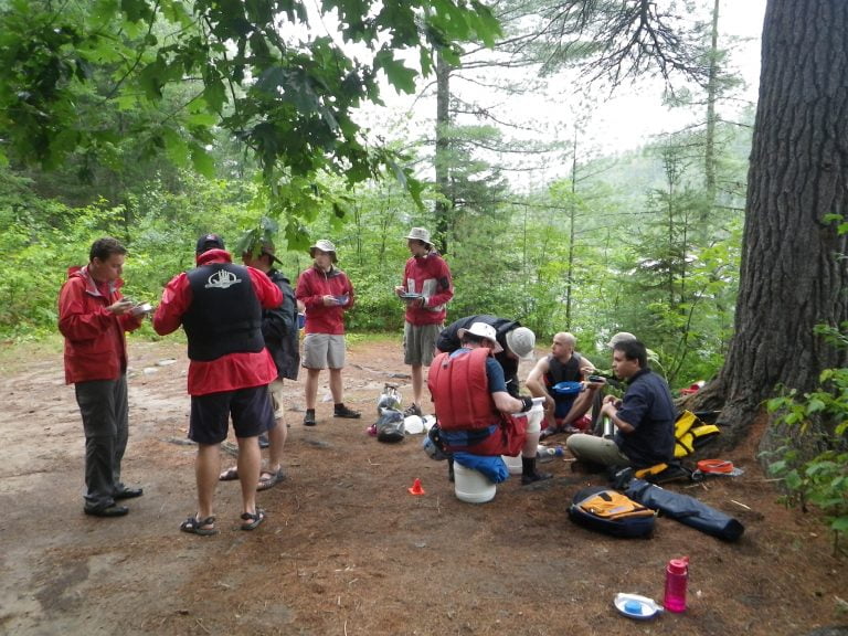 Paddlers having lunch in the forest