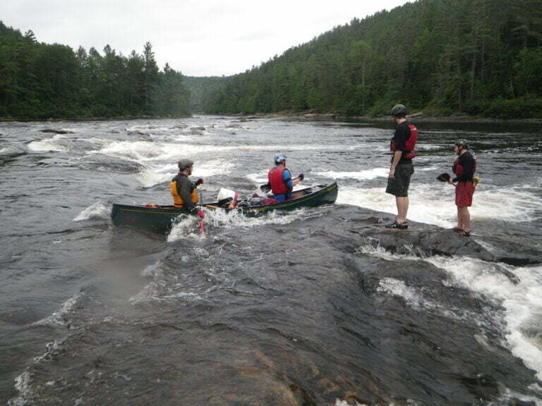 Canoe going through rapid on Coulonge river
