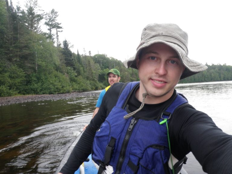Paddler taking a selfie on canoe on river