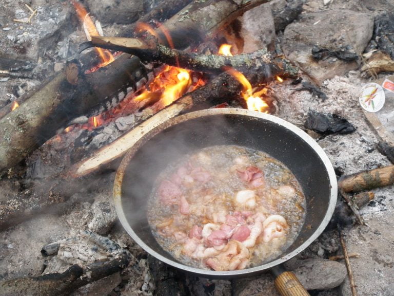 Bacon in Wok cooking on campfire