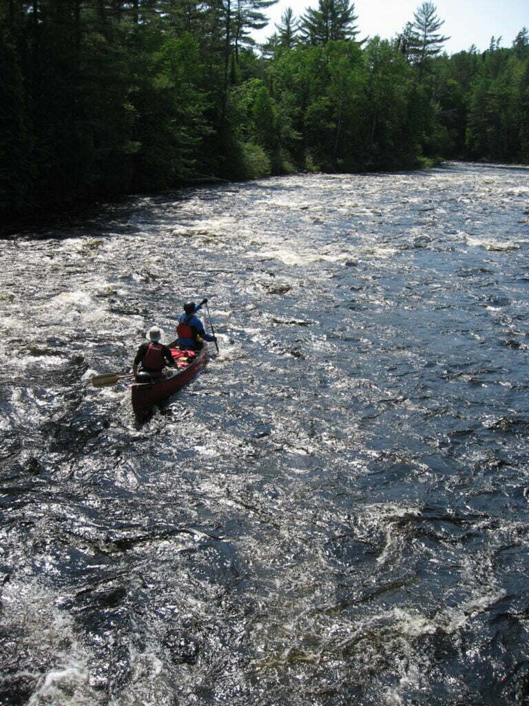 Canoe going through rapids on the Dumoine River
