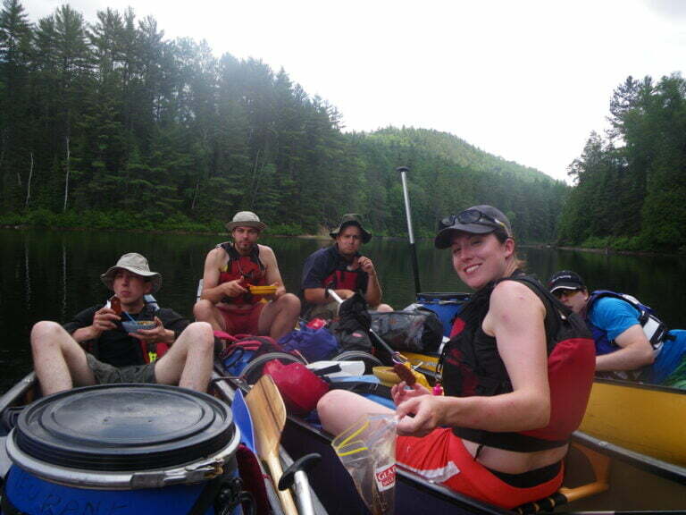 canoeists having lunch on floating canoes