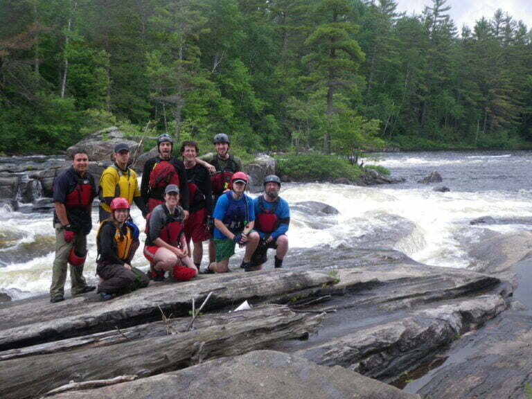 group picture in front of water ledge