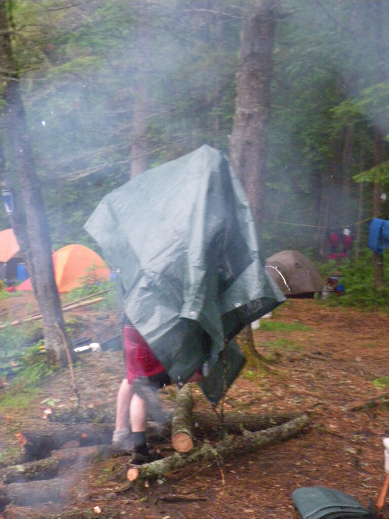 man with tarp over his head