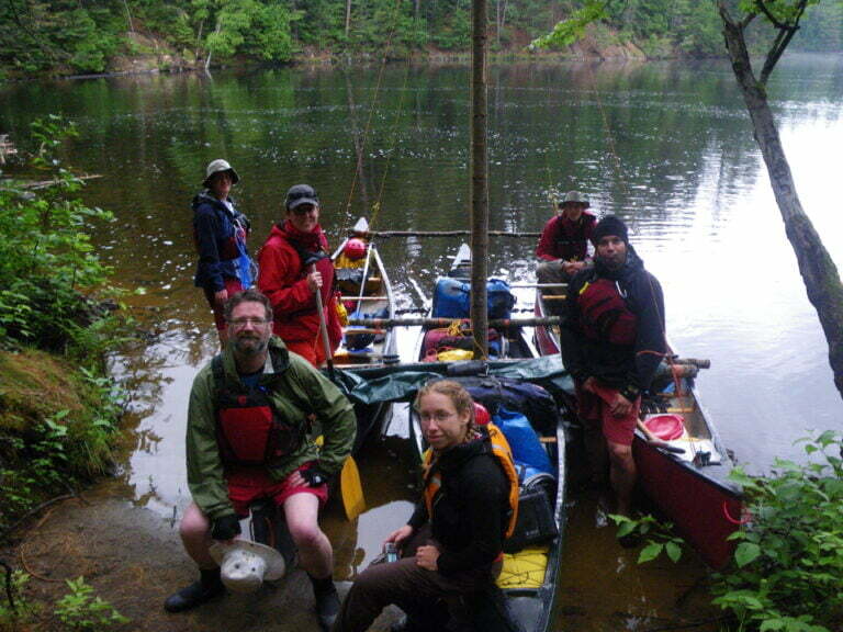 group picture in front of canoe trimaran